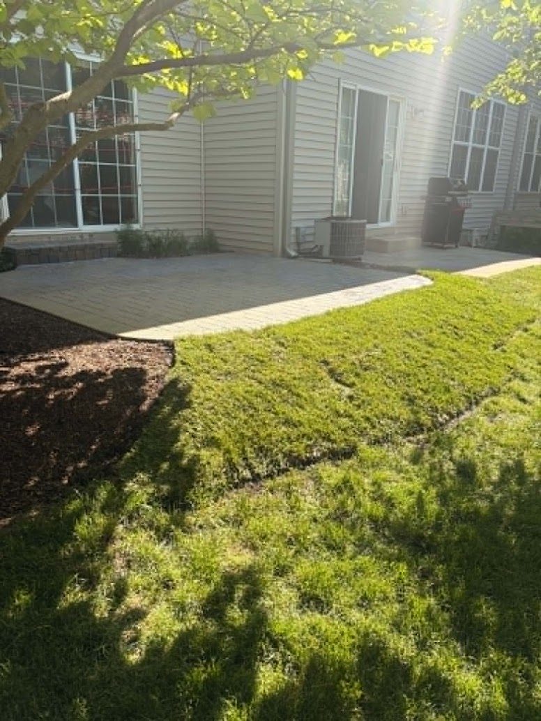 Completed patio with fresh sod laid around it by G&D Construction