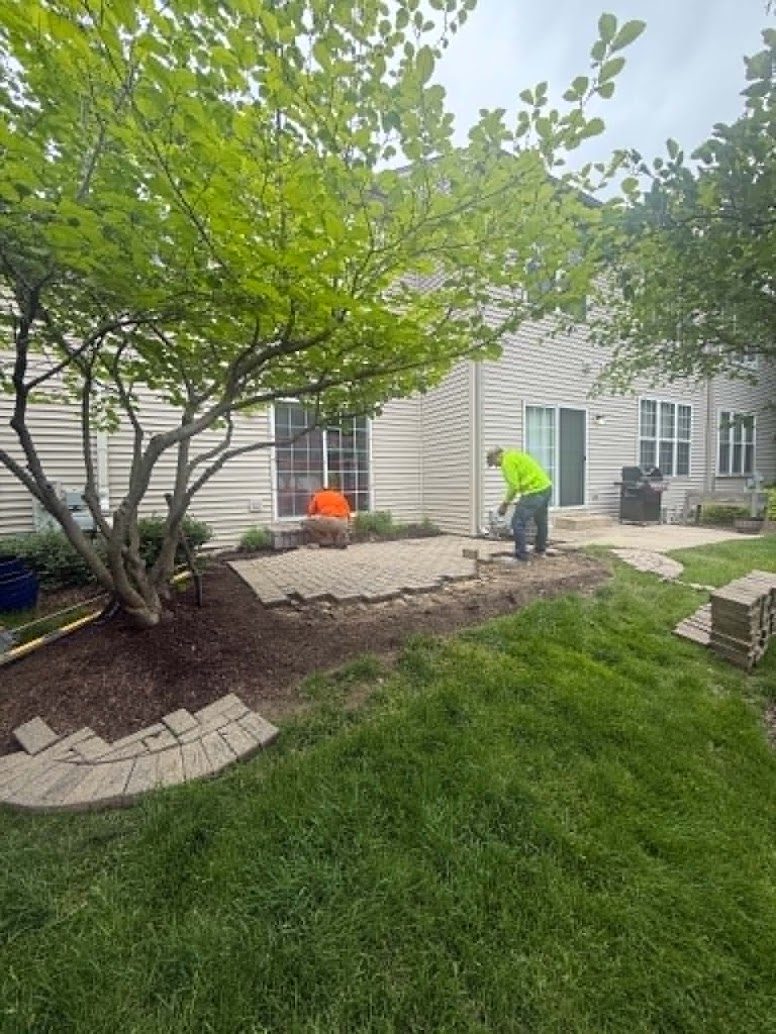 G&D Construction crew removing pavers and rebuilding the patio base